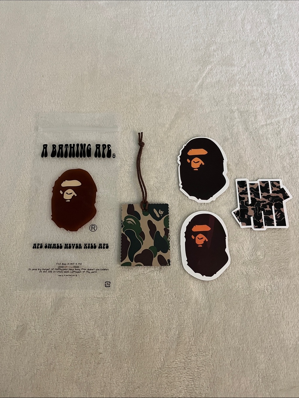 BAPE stickers, hang tag, and plastic bag